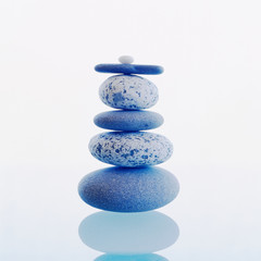Stack of balanced rocks stones isolated on white background. Meditation, zen, wellness, balance concepts.