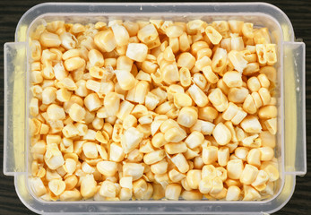 Tray with raw corn for freezing.