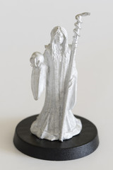 Female witch with cane and crystal ball - tin figure.