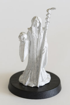 Female witch with cane and crystal ball - tin figure.