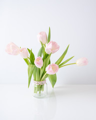 pink delicate tulips in a glass jar