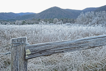 Snow on the fields and buildings of Cades Cove.