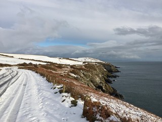 Fototapeta premium Snow covered Marine Drive, a coastline road situated on Douglas Head linking Douglas with Port Soderick in the Isle of Man.