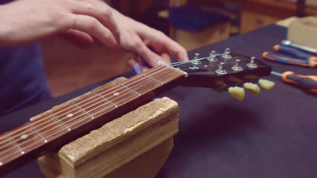 Guitarist changes guitar strings