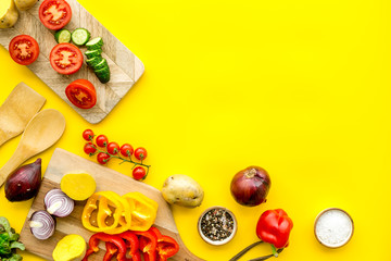 Fototapeta na wymiar Fresh food ingredients for vegetarian kitchen on yellow background top view mock-up