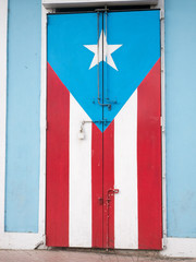 Rincon, Puerto Rico. January 2019. Wooden door with Puerto Rican flag painted on it
