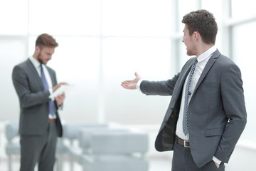 Fototapeta premium Young businessman invites to his office.