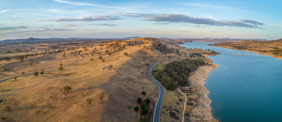 Fototapeta na wymiar Aerial view of rolling landscape and river at sunset in Australia