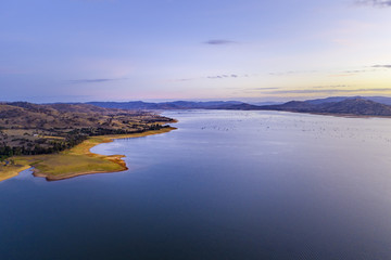 Beautiful rolling hills on Lake Hume coastline at twilight with copy space