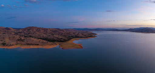 Rolling hills on Lake Hume coastline at twilight - aerial panorama with copy space