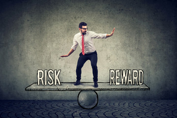 Skillful young business man balancing between reward and risk