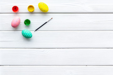 paint eggs for Easter celebration on white wooden background top view mock up