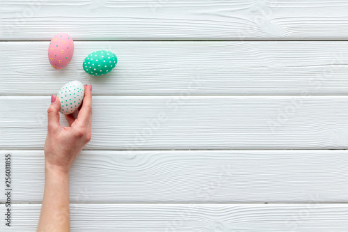 eggs with colorful paint for easter tradition on white wooden background top view mockup