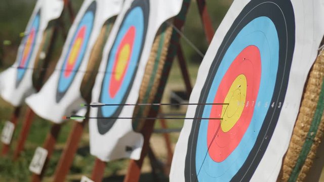 Close-up of archery targets as arrows hit the center target