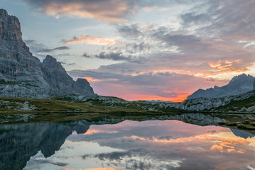 Vivid reflections of morning sky in alpine lake