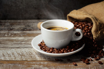 Coffee Cup And Coffee Beans On Wooden Table