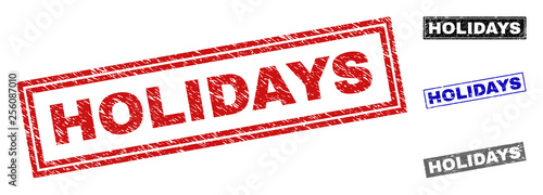 Grunge HOLIDAYS rectangle stamp seals isolated on a white background. Rectangular seals with distress texture in red, blue, black and gray colors.