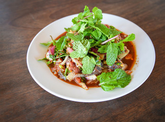 Spicy minced beef salad raw meat beef slice mixed with spices and herbs vegetable and peppermint on top
