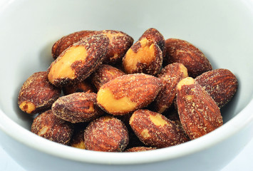 Almonds nut seeds bake salt in bowl isolated on white background