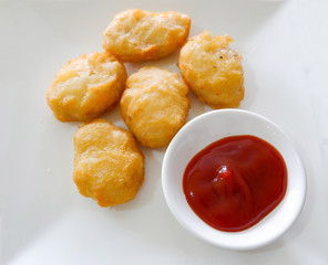 Fried chicken nuggets crispy and tomato sauce ketchup on white plate