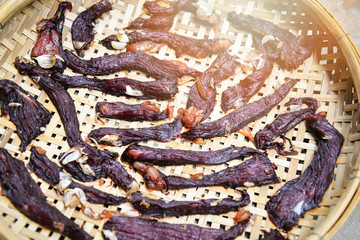 Sliced dried beef meat on the bamboo threshing make dry by sunny day