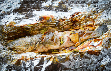 striped snakehead fish cooking grilled with salt sauce and herb on foil food