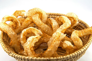 fried crispy pork scratching on basket / pork snack crackling asian food