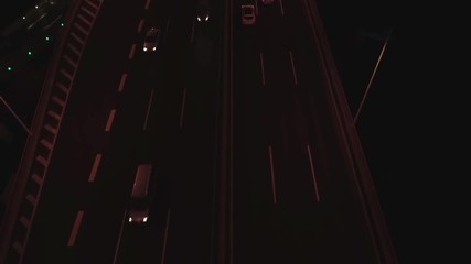 Aerial top view of highway interchange at night. Aerial top view of road junction from above, automobile traffic and jam of many cars, useful for engineering, industrial, transportation concept