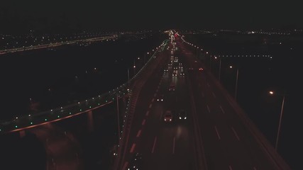 Aerial top view of highway interchange at night. Aerial top view of road junction from above, automobile traffic and jam of many cars, useful for engineering, industrial, transportation concept