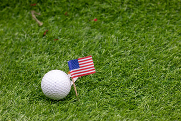 Golf ball with U.S.A. flag on green grass
