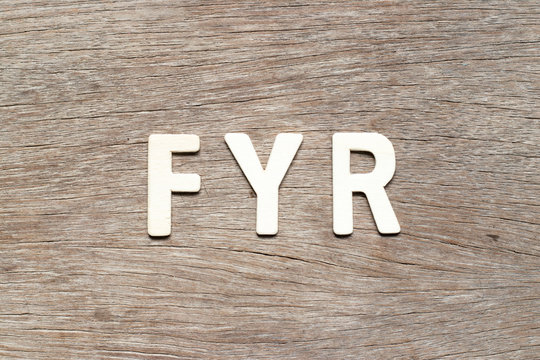 Alphabet letter in word FYR (abbreviation of for your reference) on wood background