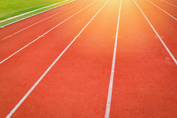 Athletics Track Run / Red running track in stadium with green field  with white line in sports outdoor