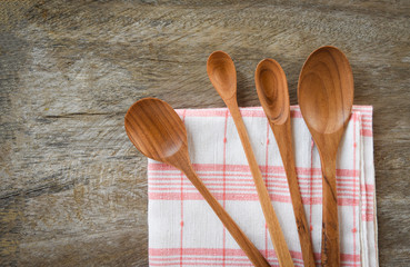 Wooden spoon and kitchenware set coffee spoon various sizes on napery on dining table
