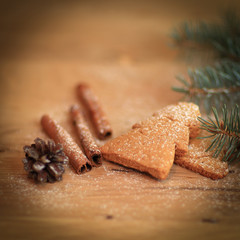 cinnamon sticks, cookies and Christmas tree branch but the tabl