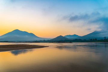 Fototapeta na wymiar Mountain river beach beautiful with colorful blue and yellow sky sunrise or sunset