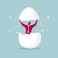 Hatching concept, a businessman opens the egg, isolated on blue background.