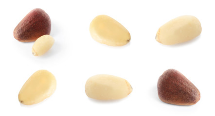 Set of different delicious organic pine nuts on white background