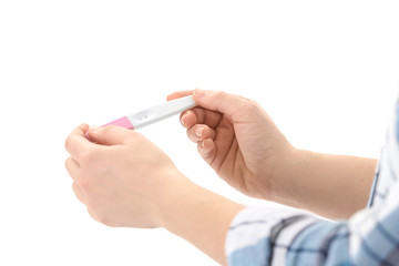Young woman with pregnancy test on white background, closeup. Gynecology and childbirth