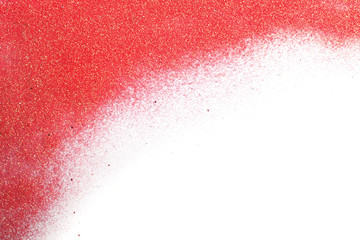 Red glitter on white background, top view