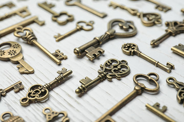 Old vintage keys on wooden background, closeup