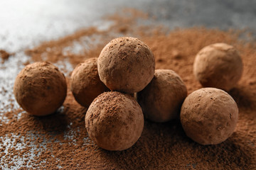Delicious raw chocolate truffles on grey background