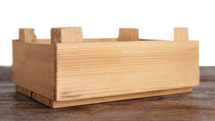 Empty rustic wooden crate on table against white background