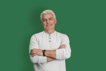 Portrait of handsome mature man on color background