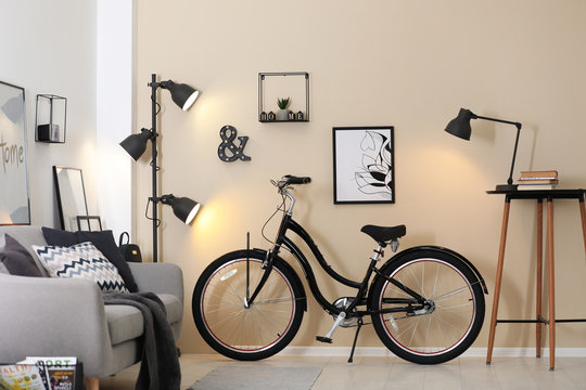 Modern living room interior with comfortable sofa and bicycle
