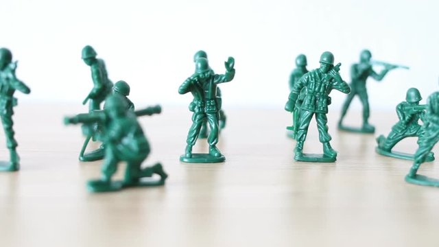 Miniature toy soldiers on wooden toy