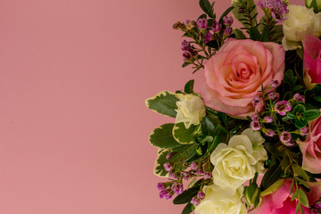 Festive flower composition on the pink background. Flat lay style, place for text. Top view and Close-up. Holiday concept. Spectacular background pastel.