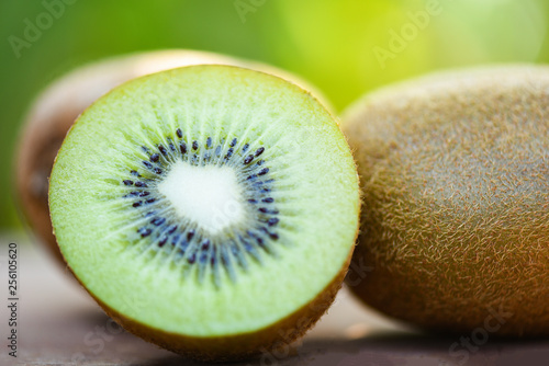 Slices Kiwi Close Up And Fresh Whole Kiwi Fruit On Wooden
