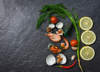 Seafood plate with shrimps prawns cooked shellfish mussel cockles boiled lemon herbs and spices