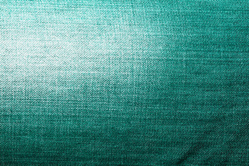 Shabby denim texture for background. Green jeans 