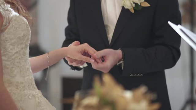 wedding couple exchange rings close up